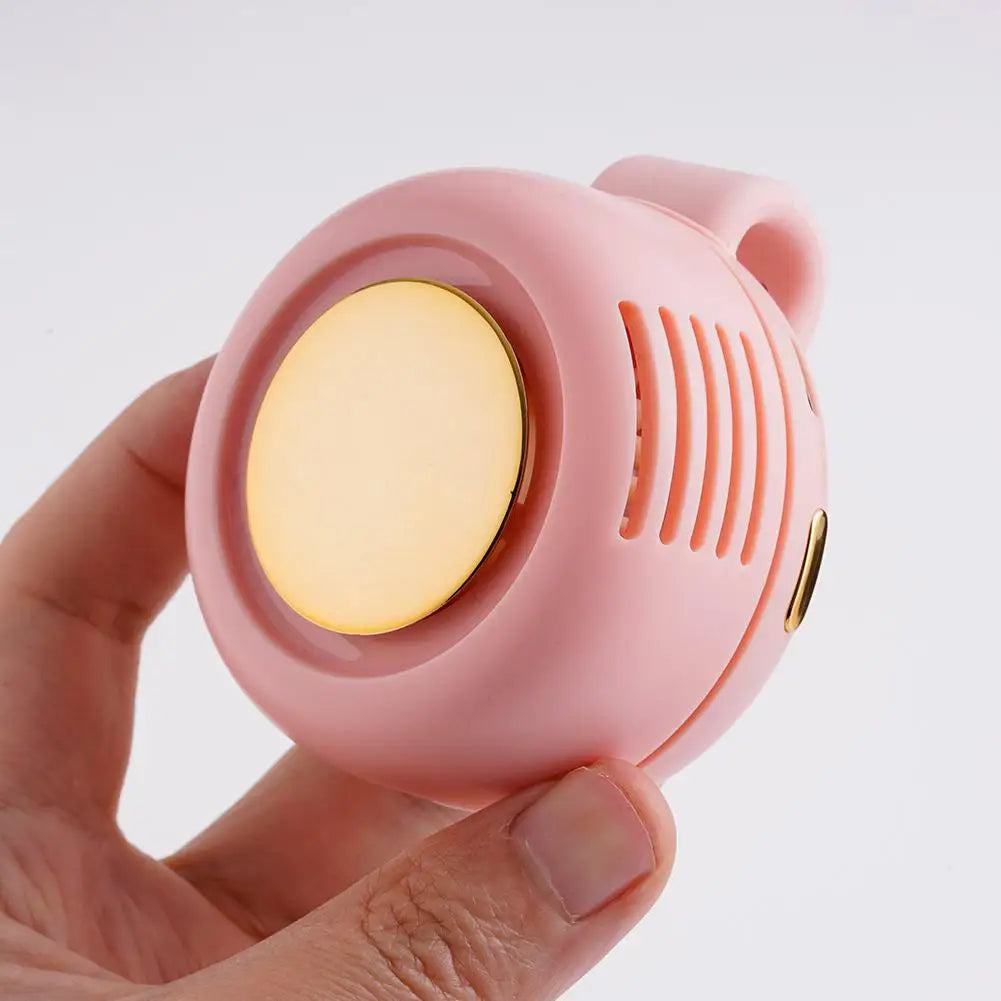 Pink and gold device held in a hand against a white background