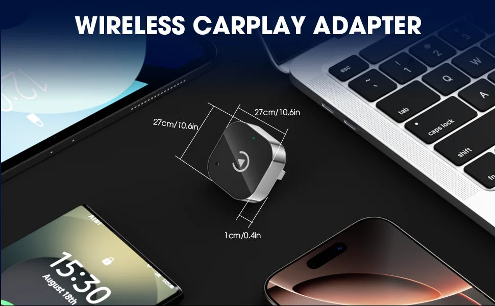 Wireless CarPlay adapter with smartphone, laptop, and computer monitor on a dark surface