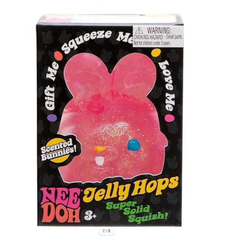 Pink jelly bunny toy in packaging with text and warning label.