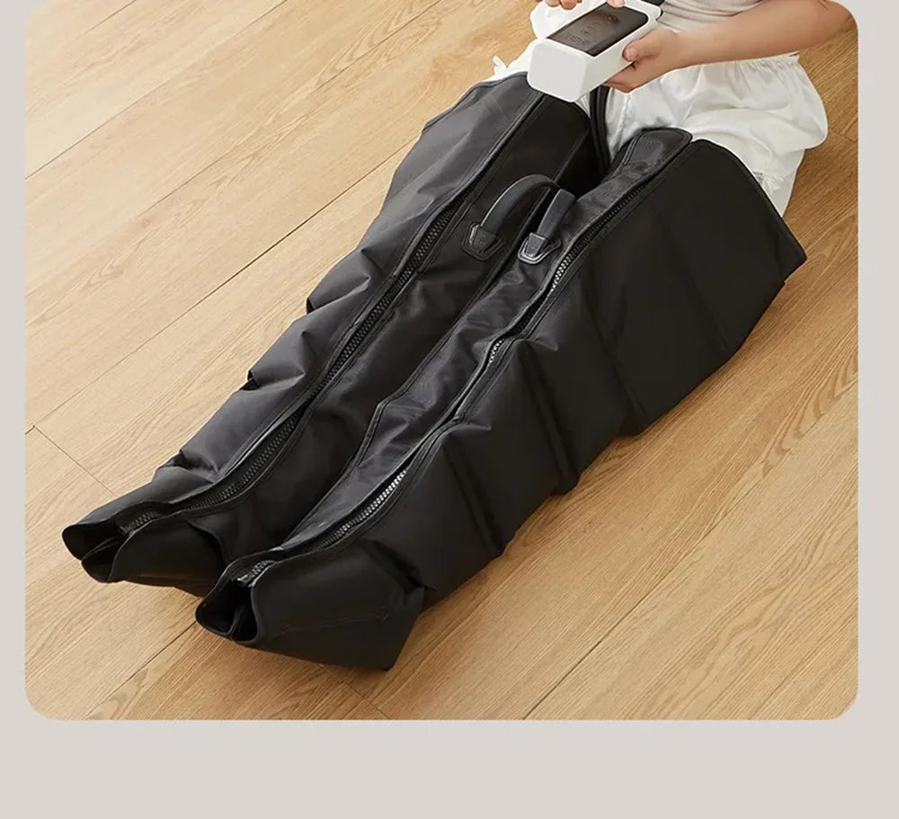 Black garment bag on a wooden floor with a person holding a smartphone above it.