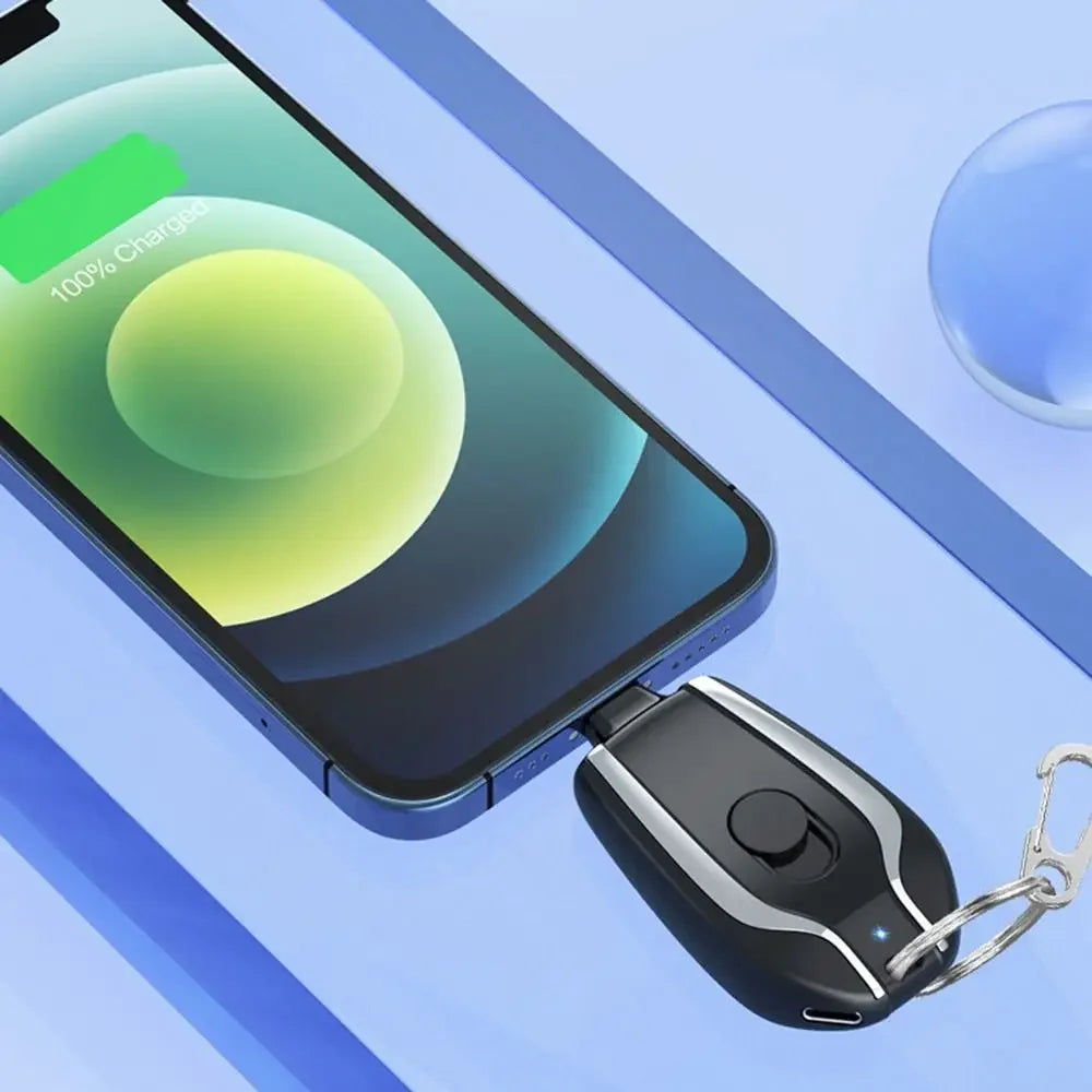 Smartphone with a charging case and keychain device on a blue background